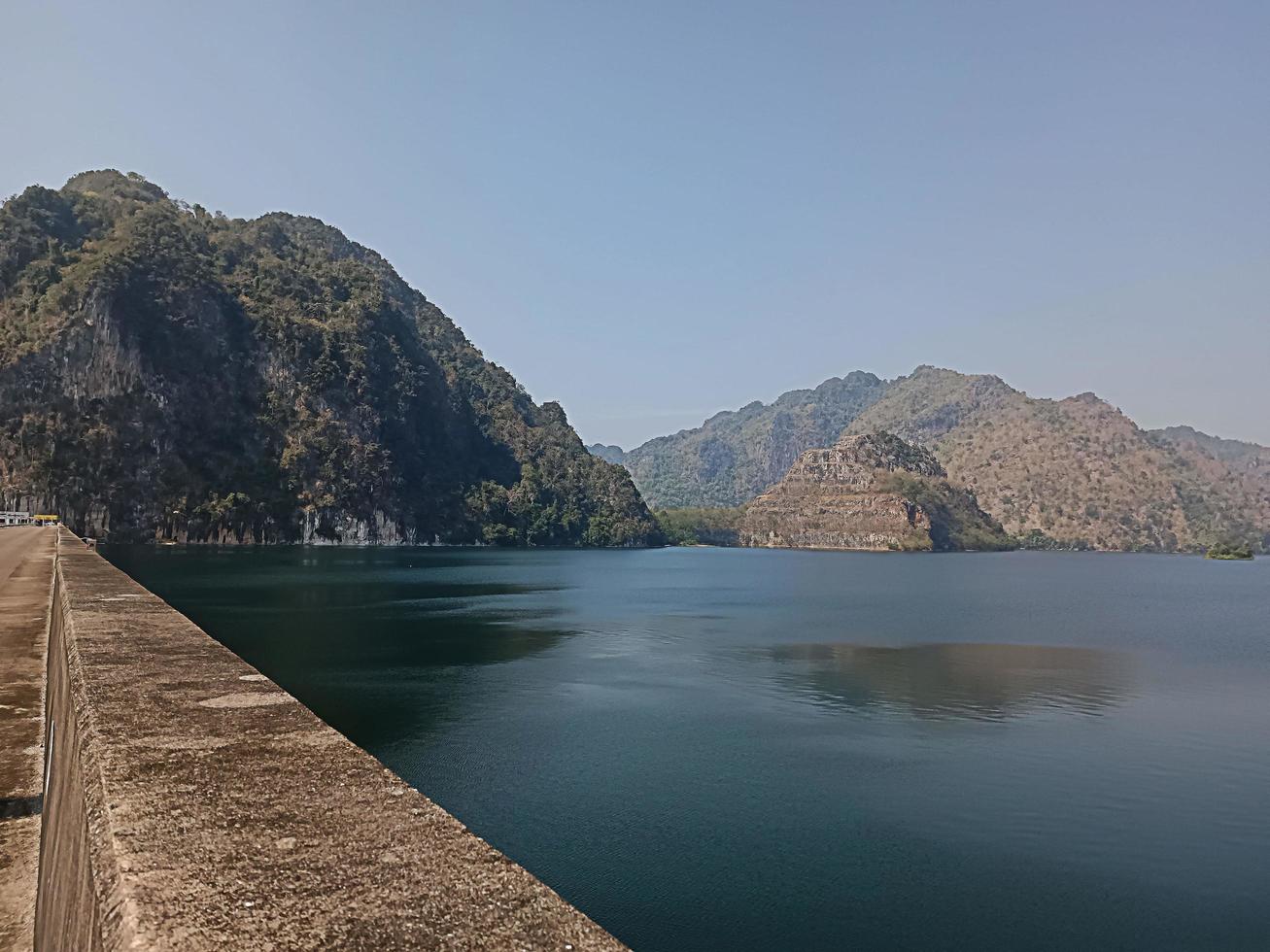 View of the river surrounded by mountains on the dam photo