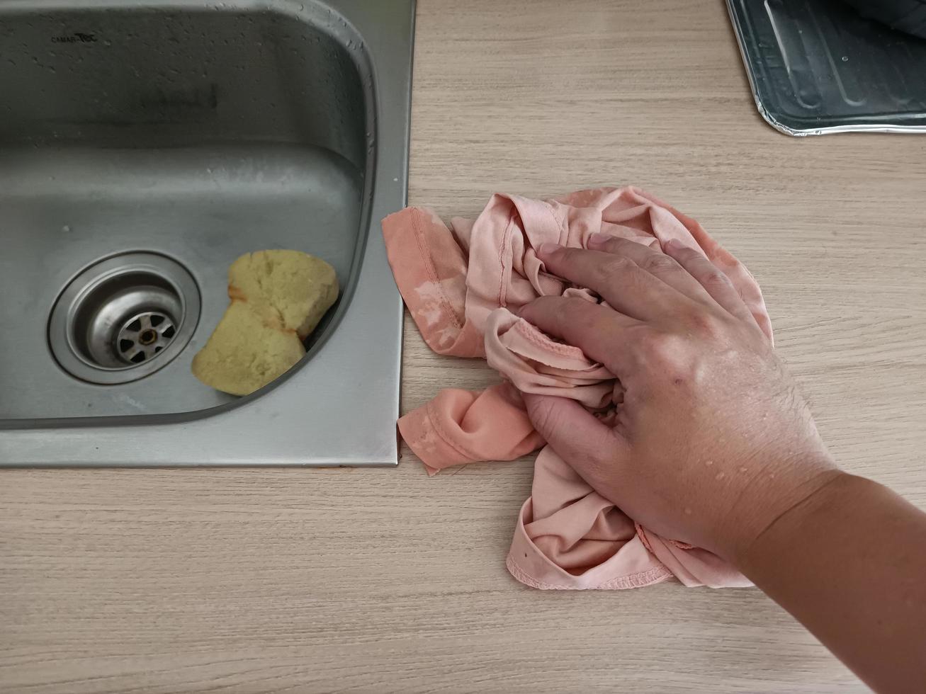 A housewife is cleaning the kitchen counter neatly. photo