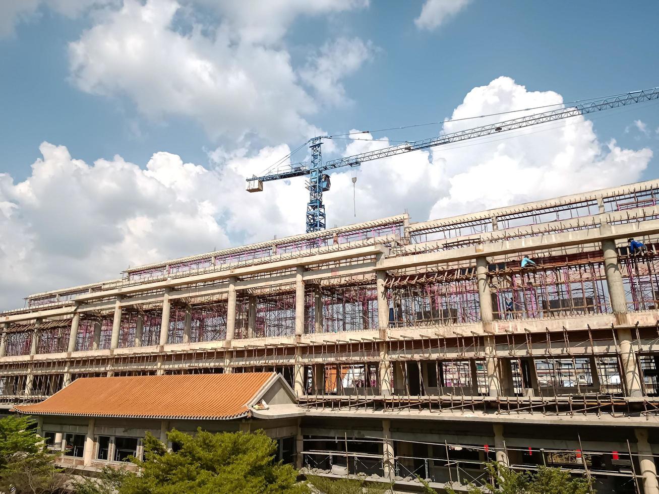 Large crane and construction of building daytime photo