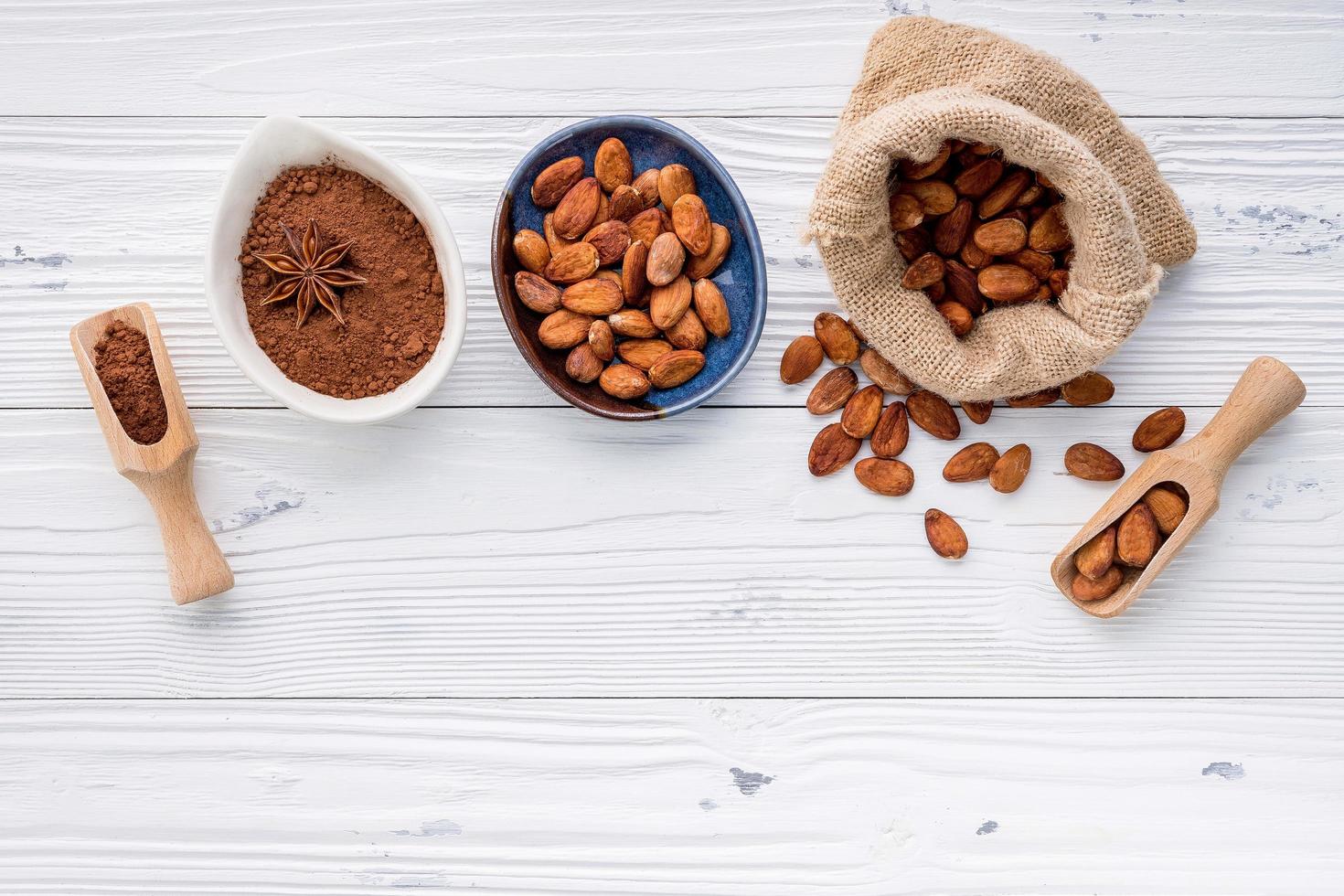 Cocoa powder and cacao beans on wooden background. photo