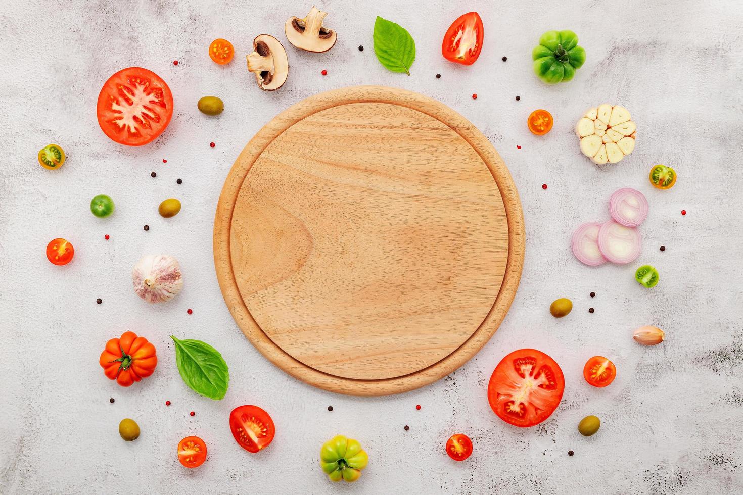 The ingredients for homemade pizza set up on white concrete background. photo