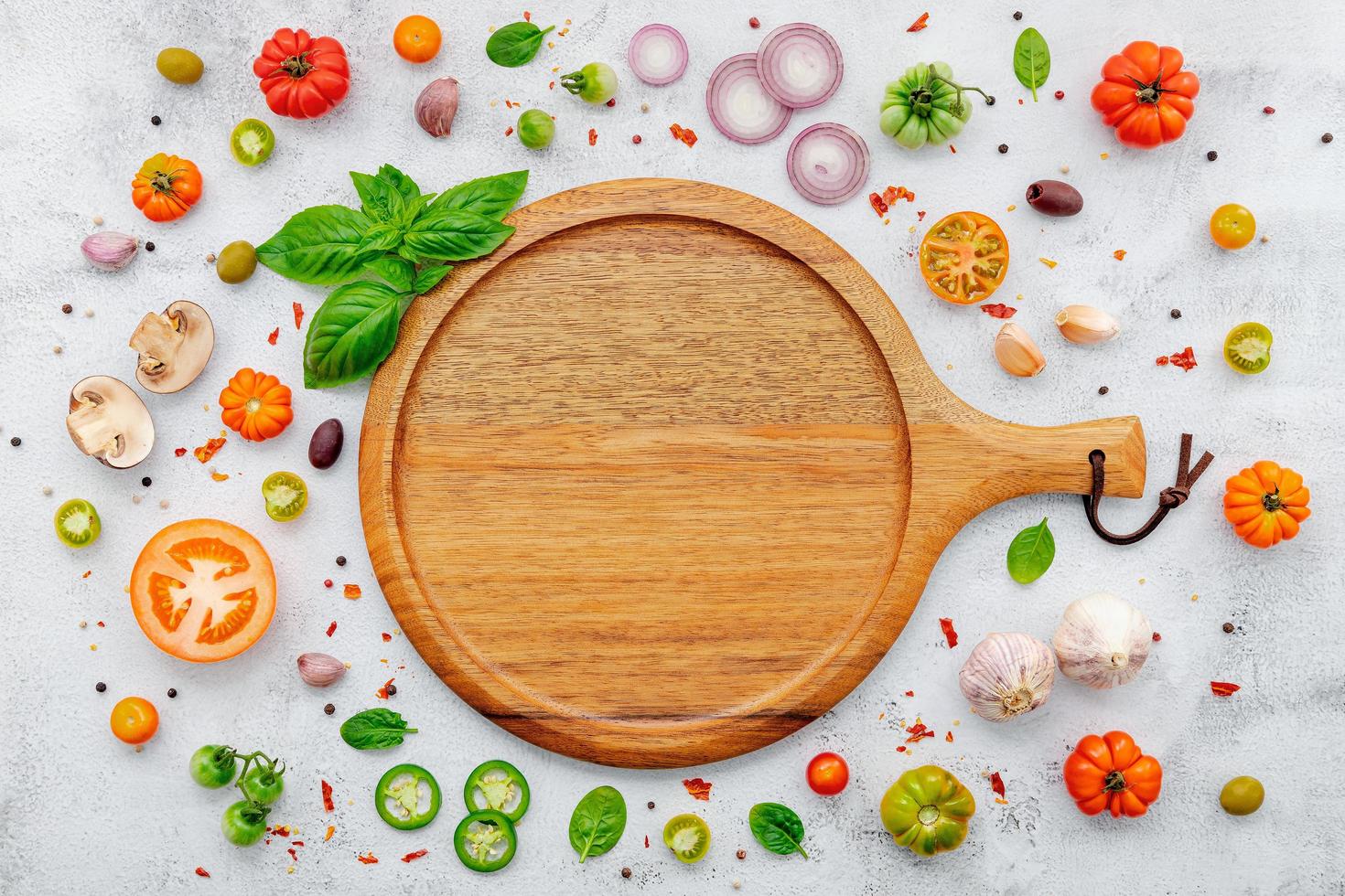 The ingredients for homemade pizza set up on white concrete background. photo