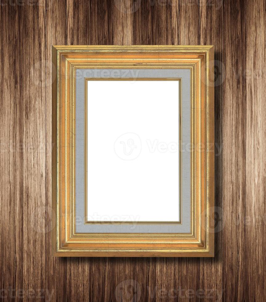 antique gold frame on wooden wall photo