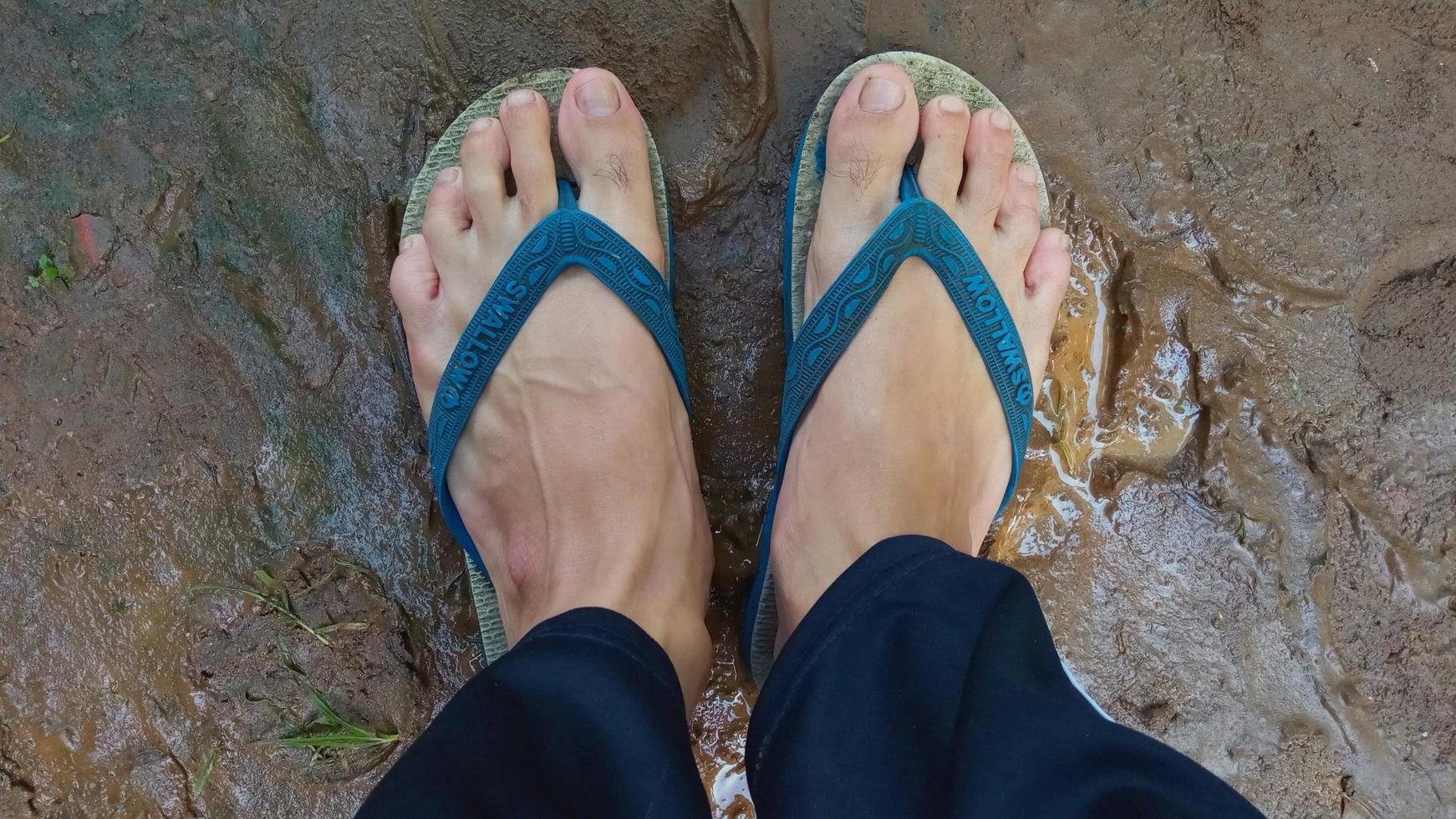 Cianjur Regency, West Java, Indonesia on March 16, 2022 Two pairs of flip-flops in the yard.  Photos to complement the article.