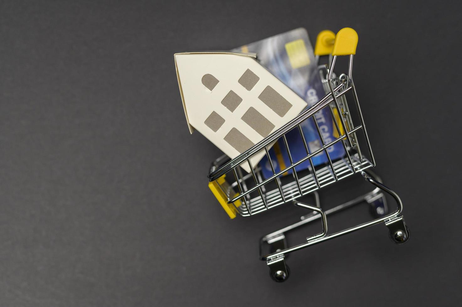 Small white model home over black background studio photo