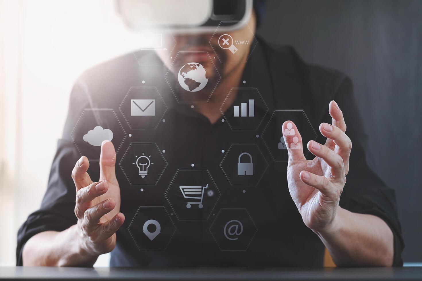 businessman wearing virtual reality goggles in modern office with mobile phone using with VR headset with screen icon diagram photo