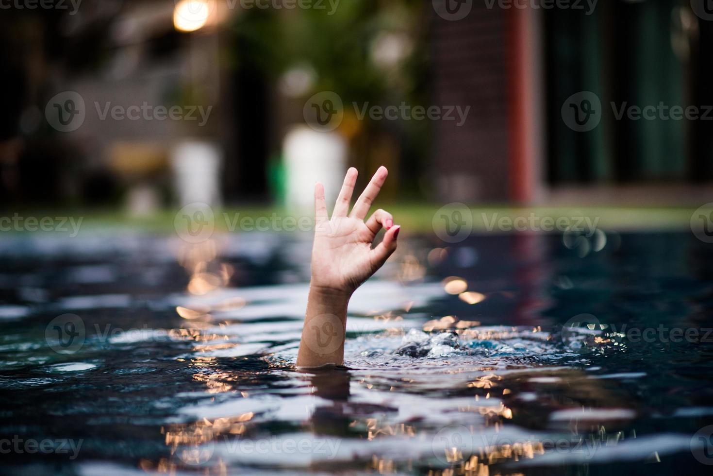Hand and water love hand that comes out of the water that is also shown ok. photo