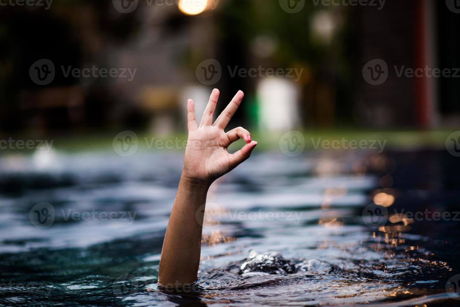 Hand and water love hand that comes out of the water that is also shown ok. photo