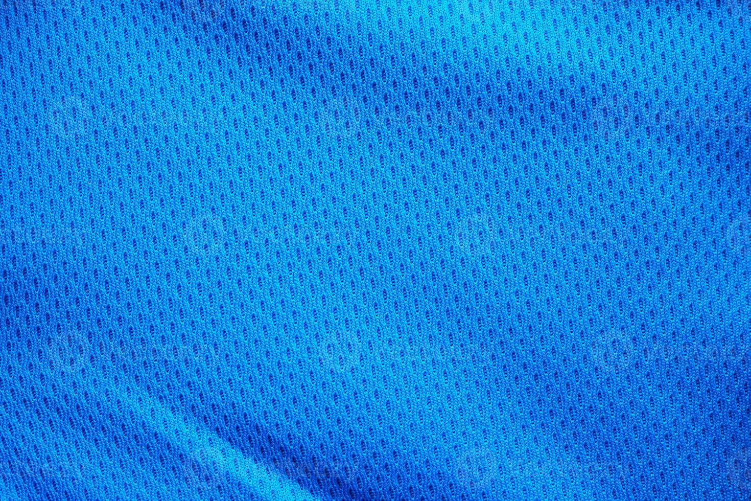 Blue fabric sport clothing football jersey with air mesh texture background photo