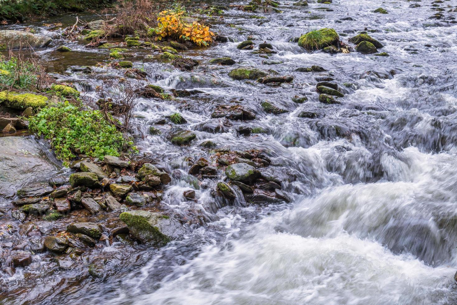 View of fast flowing water in the East Lyn River photo