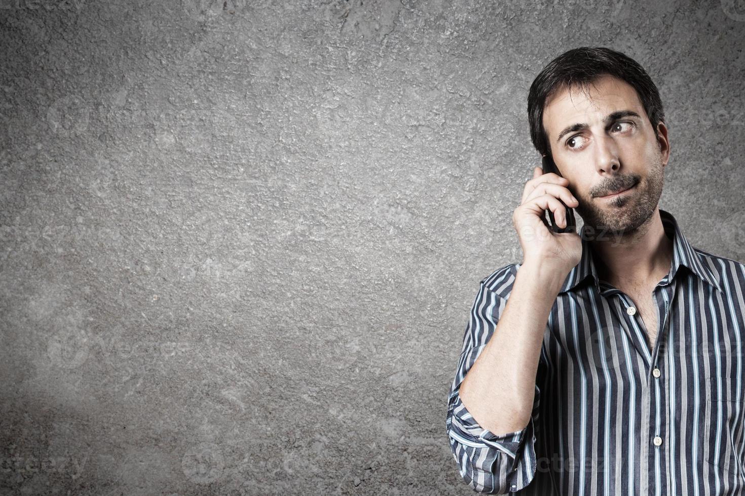 Portrait of expectant man while listen a call phone. photo