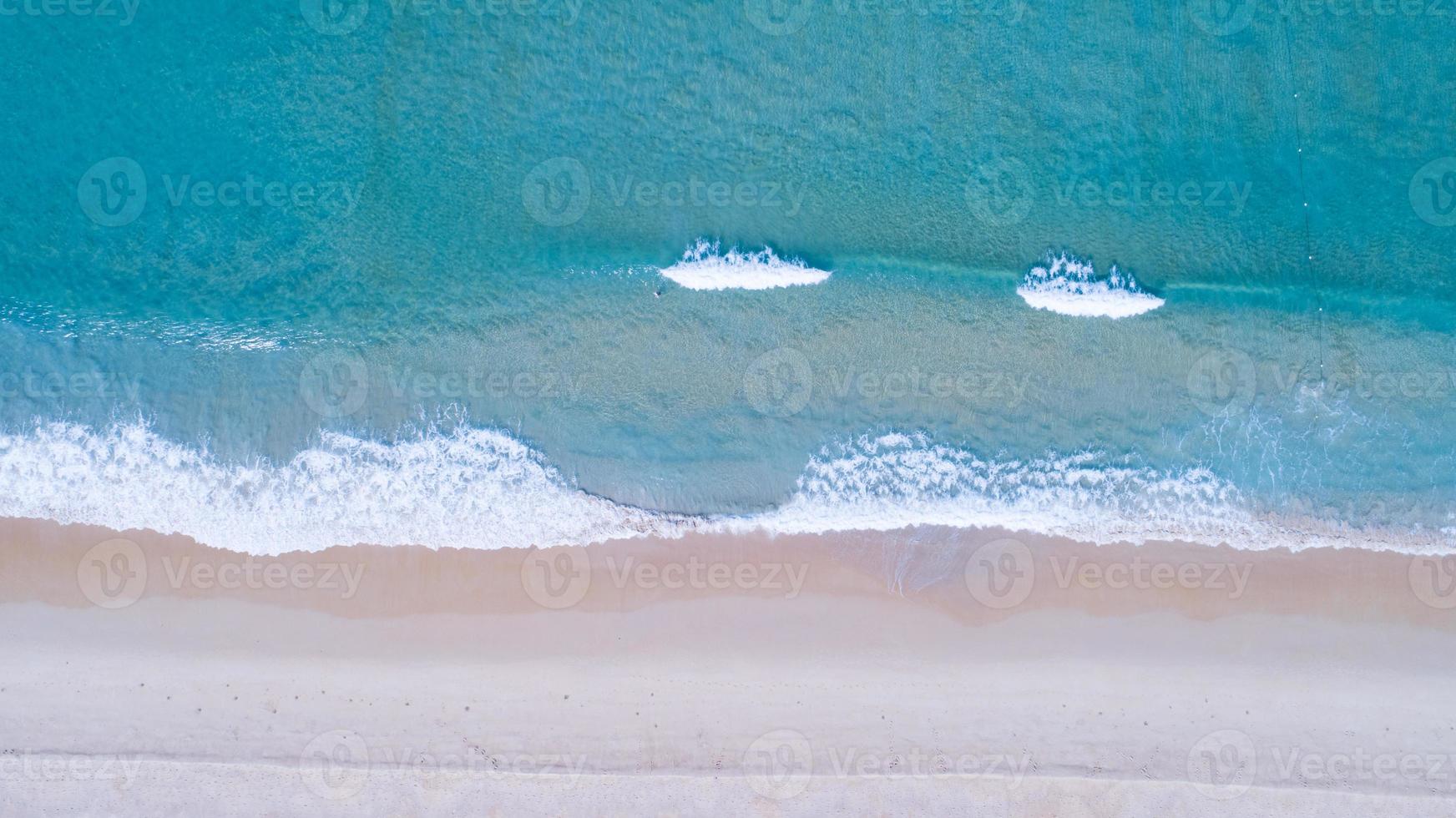 Aerial view sandy beach and waves Beautiful tropical sea in the morning summer season image by Aerial view drone shot, high angle view Top down photo