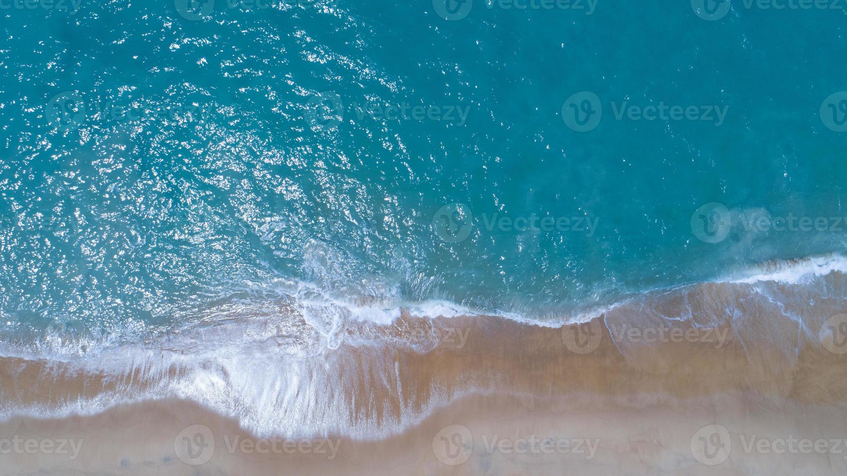 Aerial view sandy beach and waves Beautiful tropical sea in the morning summer season image by Aerial view drone shot, high angle view Top down photo