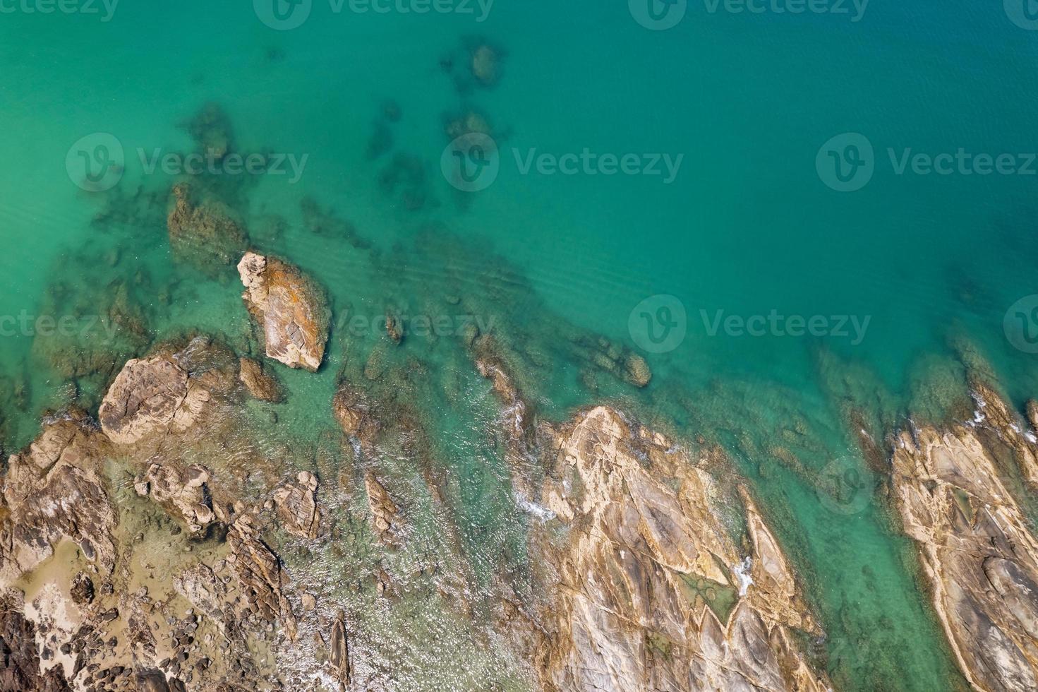 Aerial view Top down seashore rocks sea surface in sunny day Good weather day summer background photo