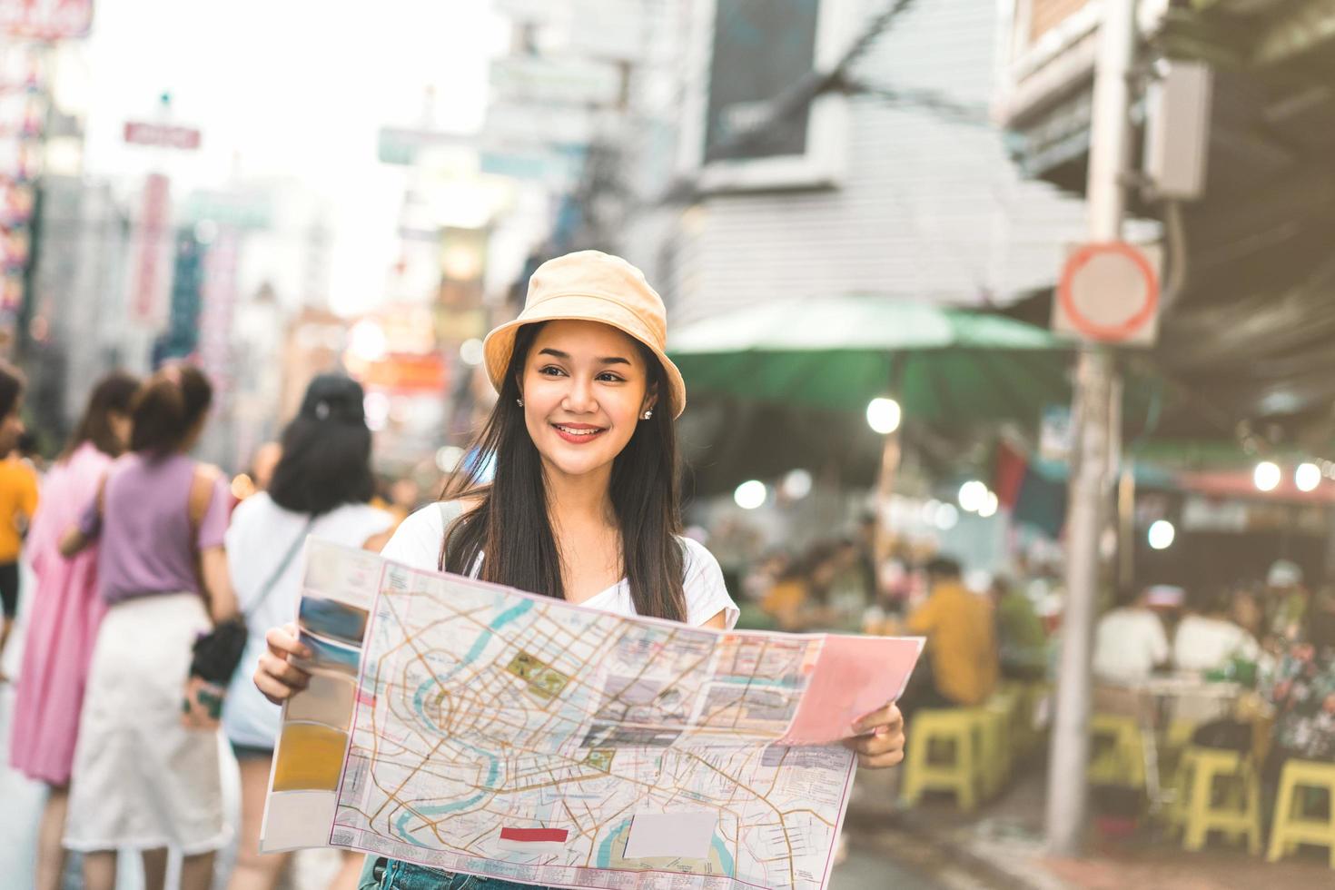 Asian woman searching with map in chinatown photo