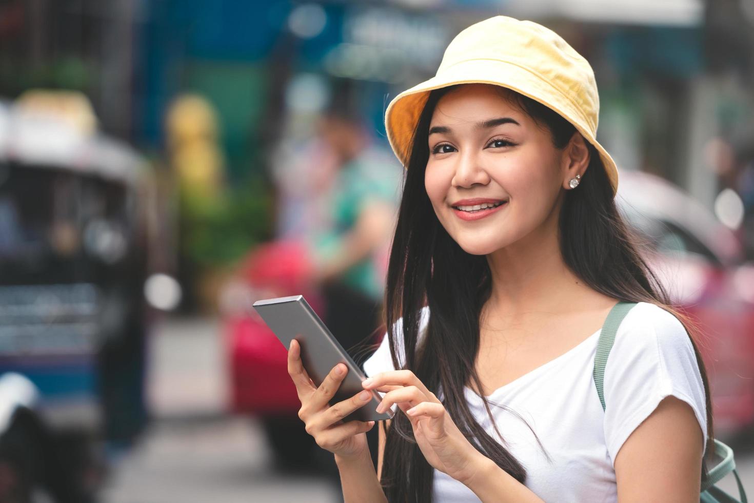 Asian traveller woman relax journey with smartphone in Bangkok city. photo