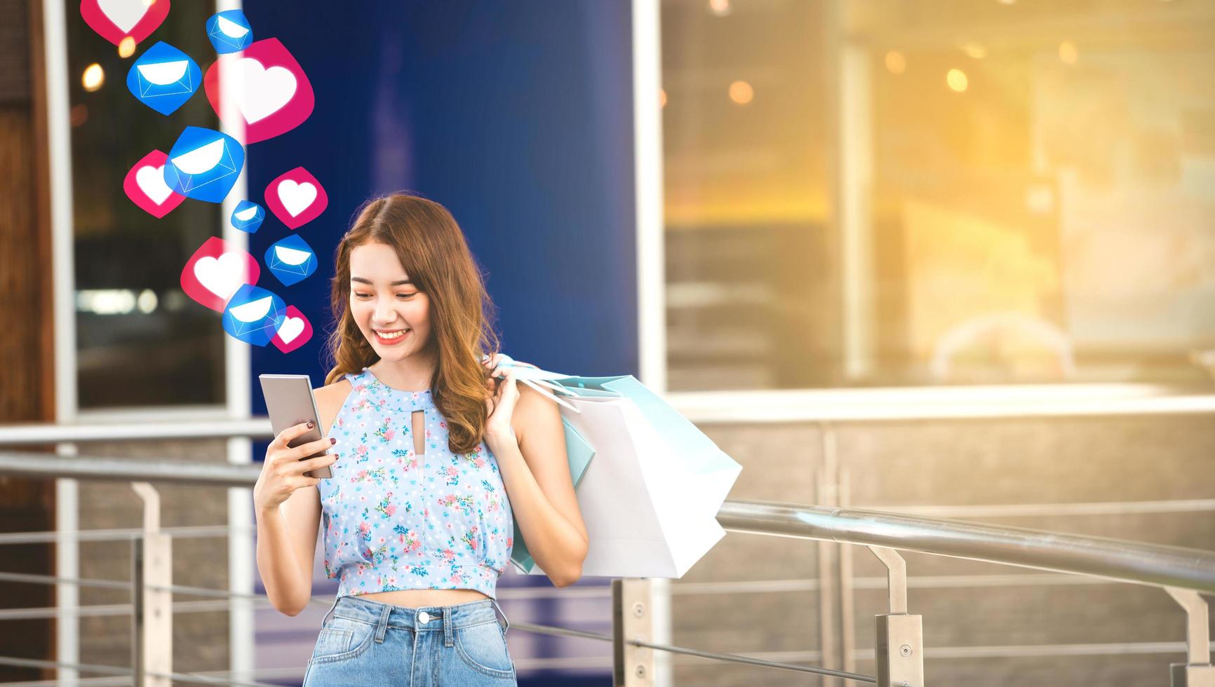 Asia young woman use mobilephone when shopping photo