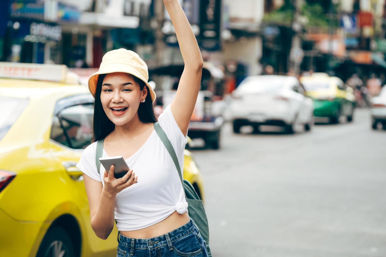 mujer viajera asiática relajarse viaje con teléfono inteligente en la ciudad de bangkok. foto