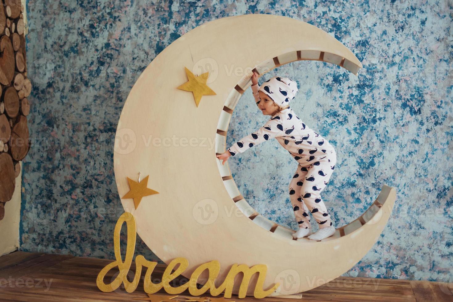 Child in soft and warm pajamas lying photo