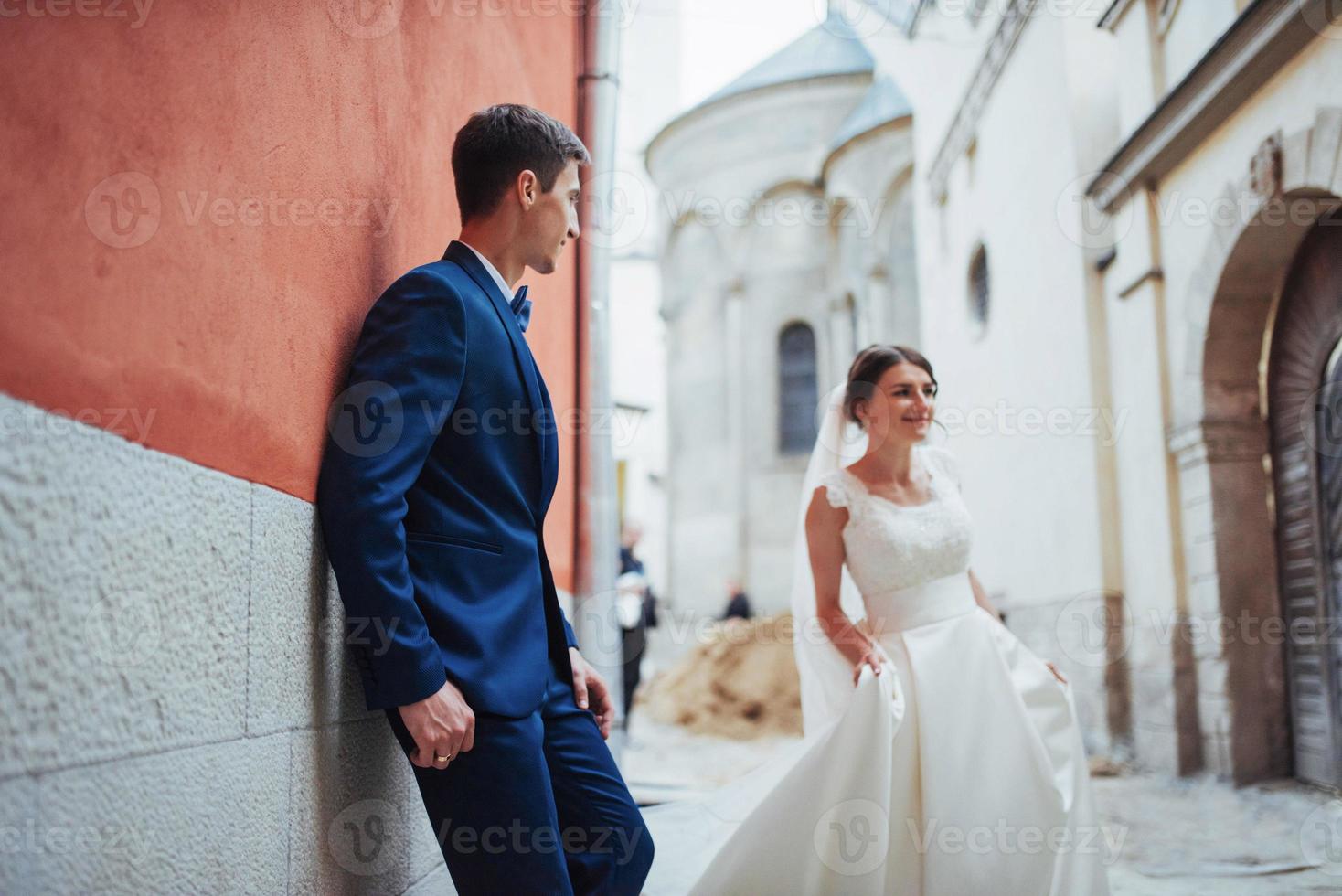 Wedding portrait of a happy couple. Stand and kissing photo