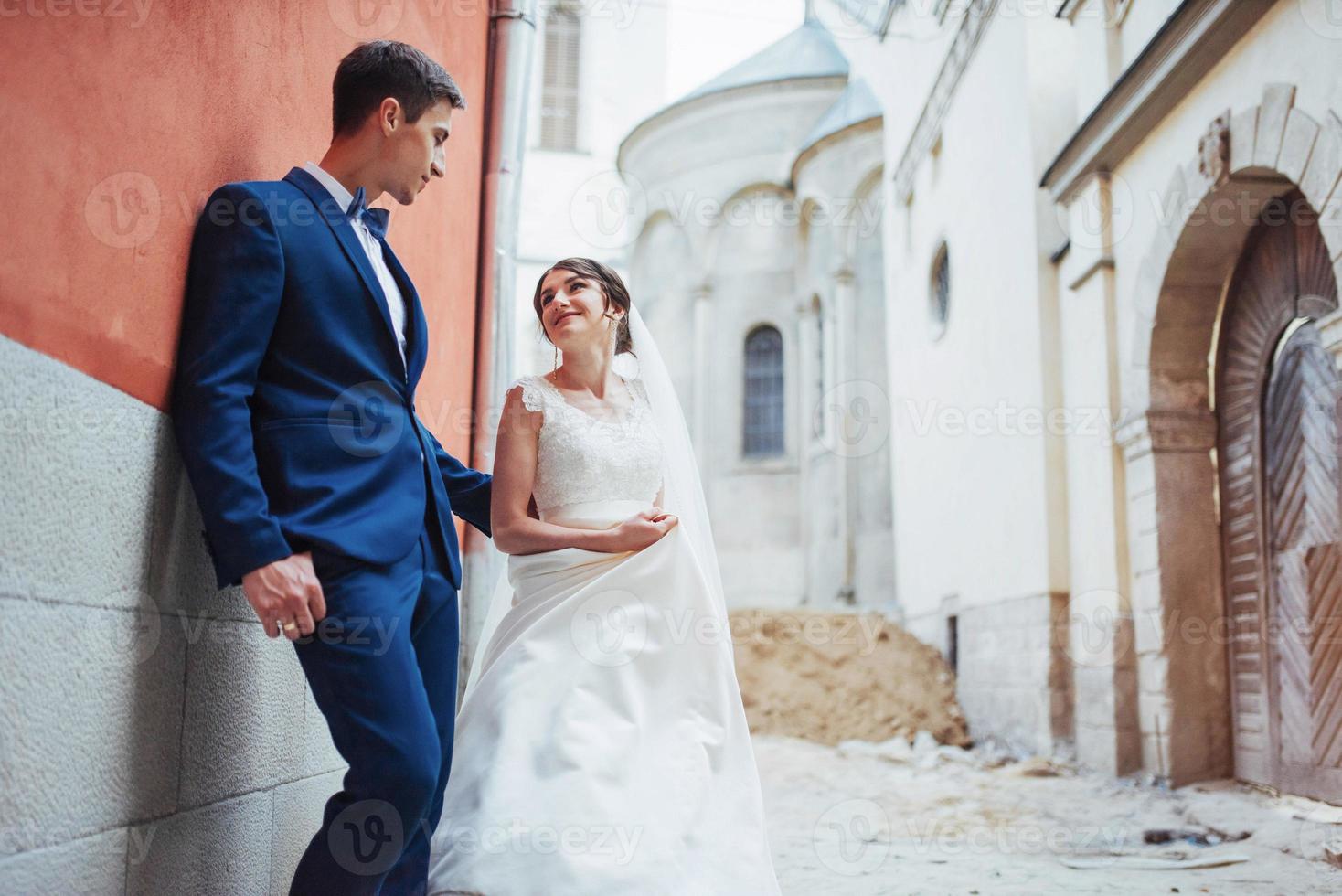 Wedding portrait of a happy couple. Stand and kissing photo