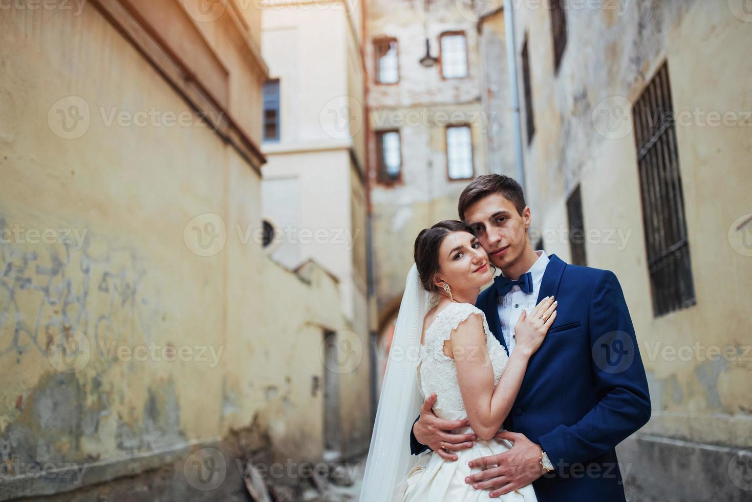 Wedding portrait of a happy couple. Stand and kissing photo