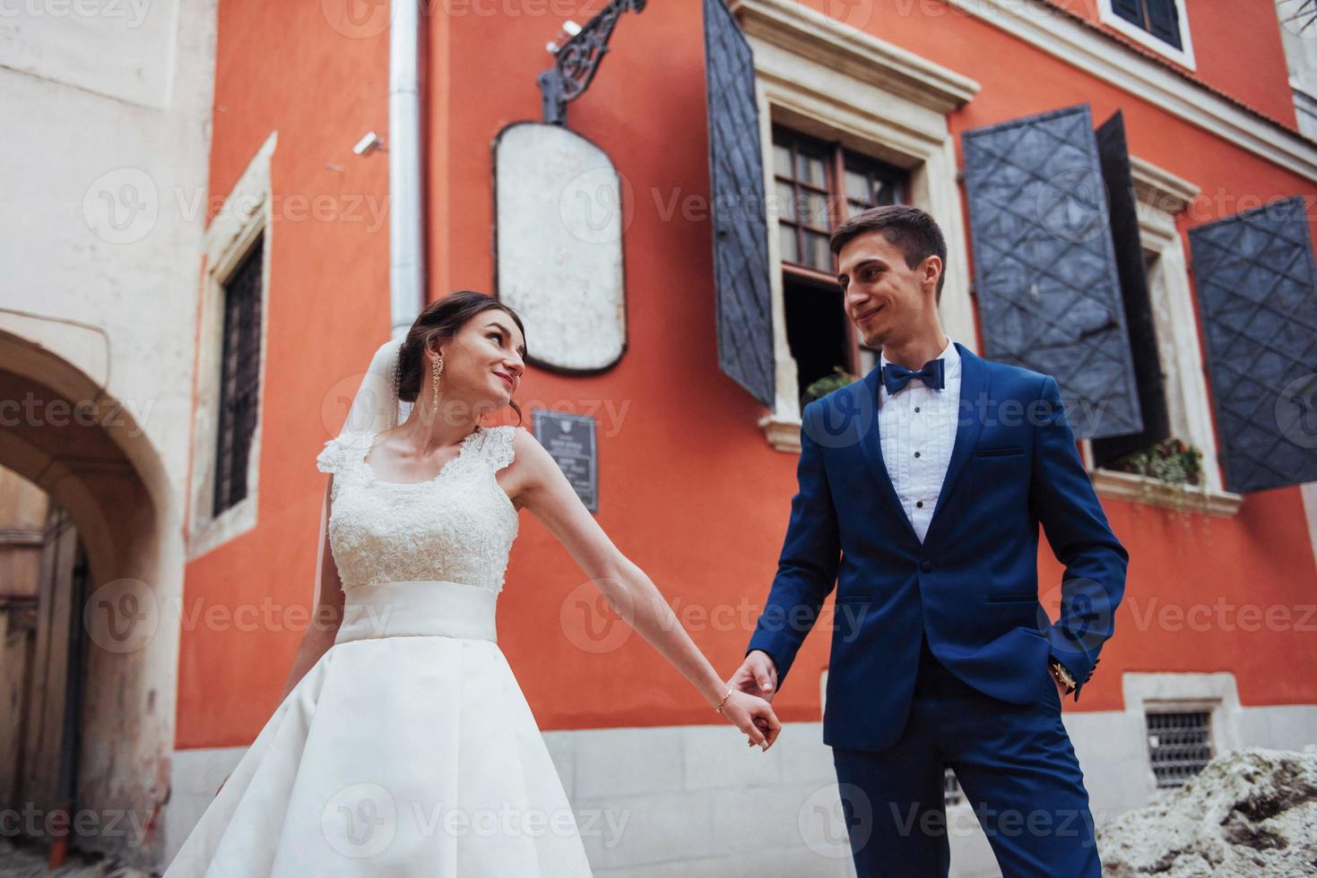 Wedding portrait of a happy couple. Stand and kissing photo