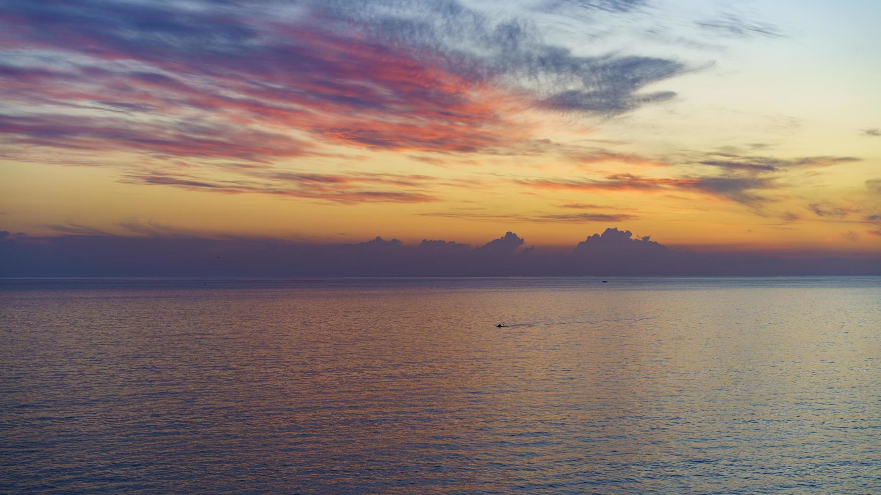 Seascape with a beautiful sunset over the water surface photo