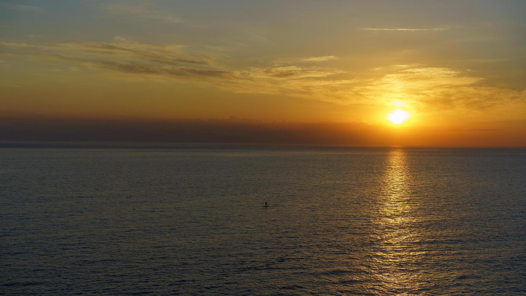 Seascape with a beautiful sunset over the water surface photo