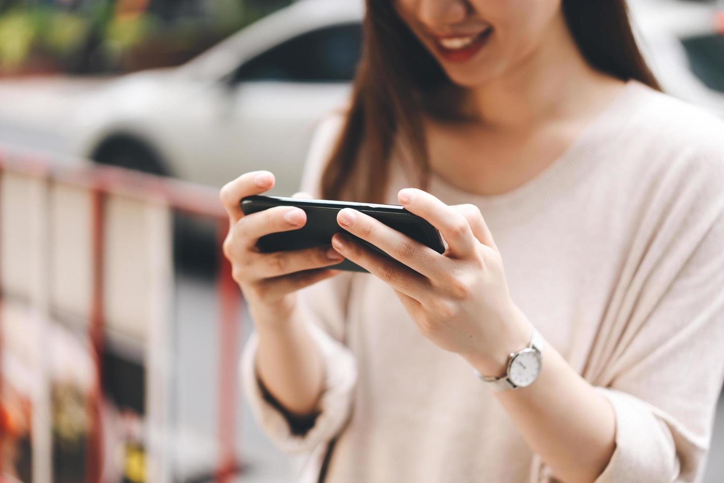 Woman holding smart phone connect online media via 5g internet photo