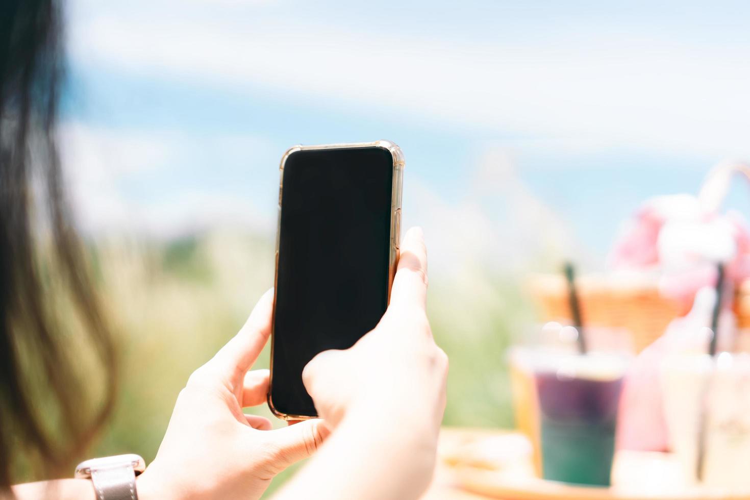 Close up of young female hand using mobile phone for take a picture for social technology. photo