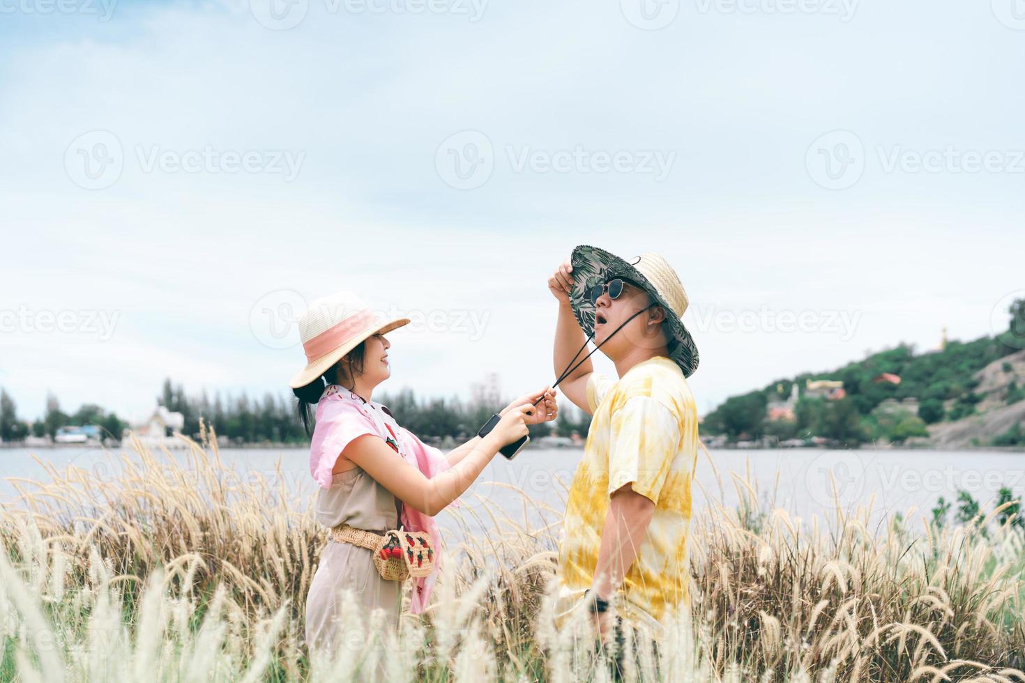 Young adult traveller asian funny couple relax outdoor trip on summer holidays. photo