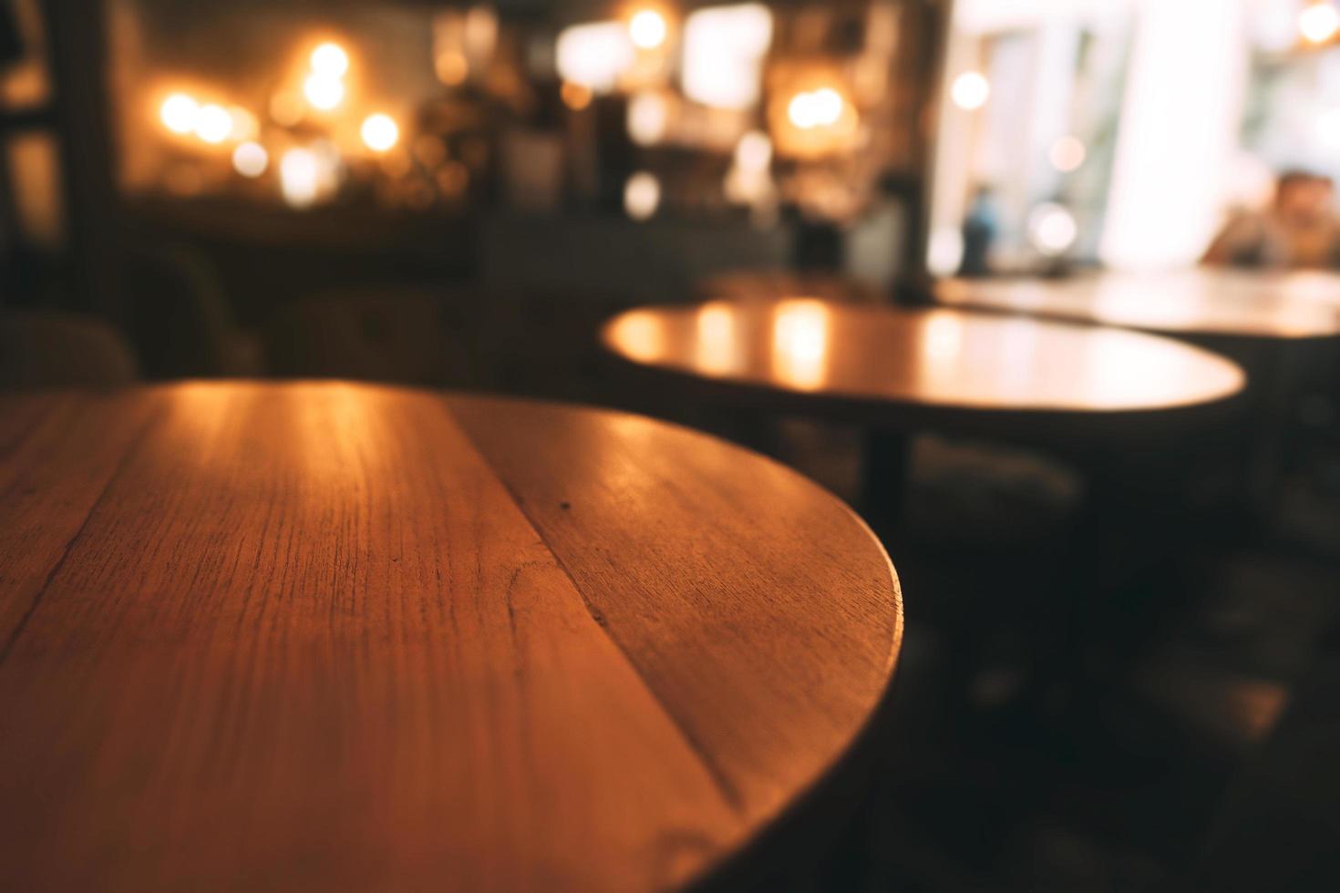 Mahogany wood table surface in warm luxury style cafe. photo