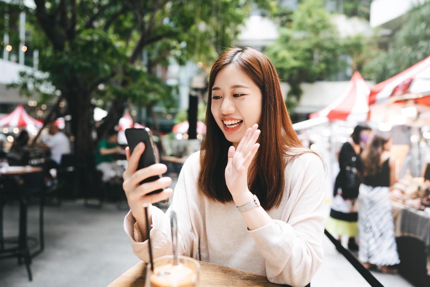 Young adult business asian woman use tablet for business at outdoor cafe photo