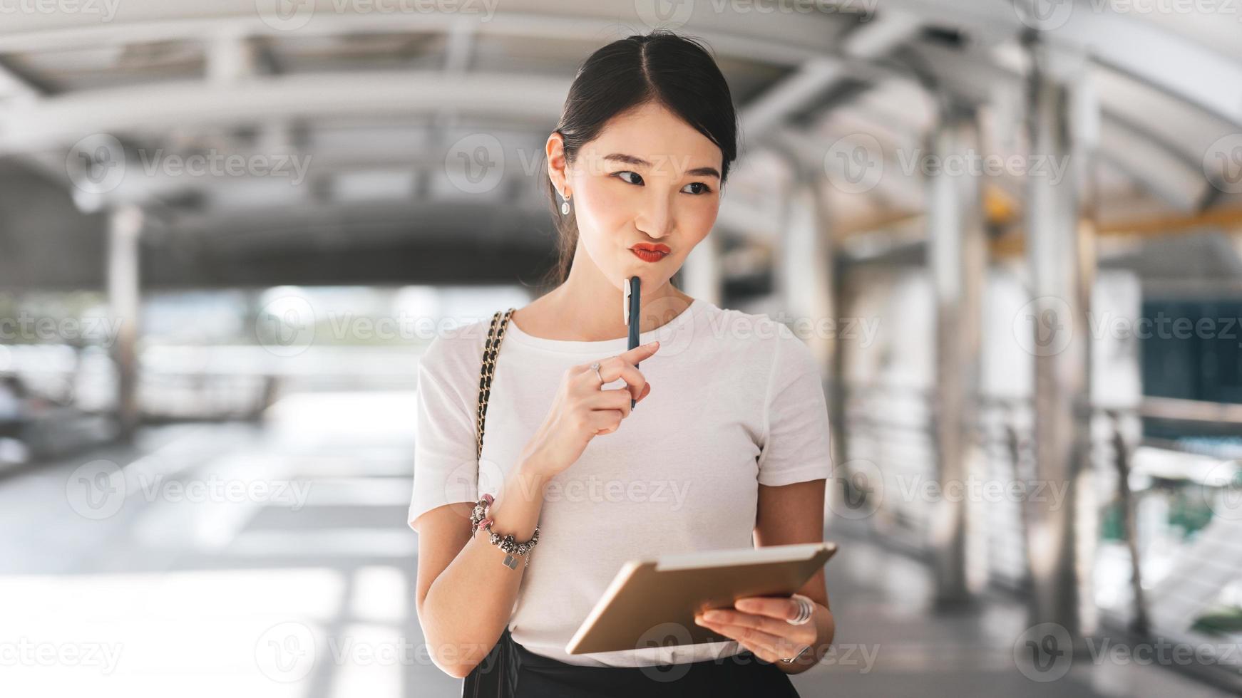 Young adult business working asian woman using digital portable tablet on day. photo