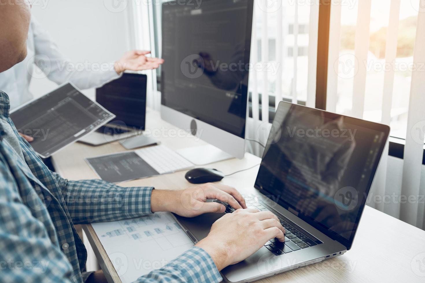 Two asian team working development of programming and encryption technology website design programmers on desk in office. photo