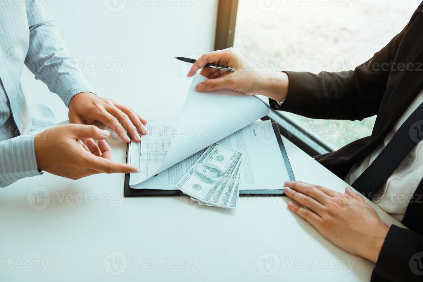 Partner has made a fraud in the contract of sale and being handed a cash and pen to the businessman signing the contract corruption bribery concept. photo