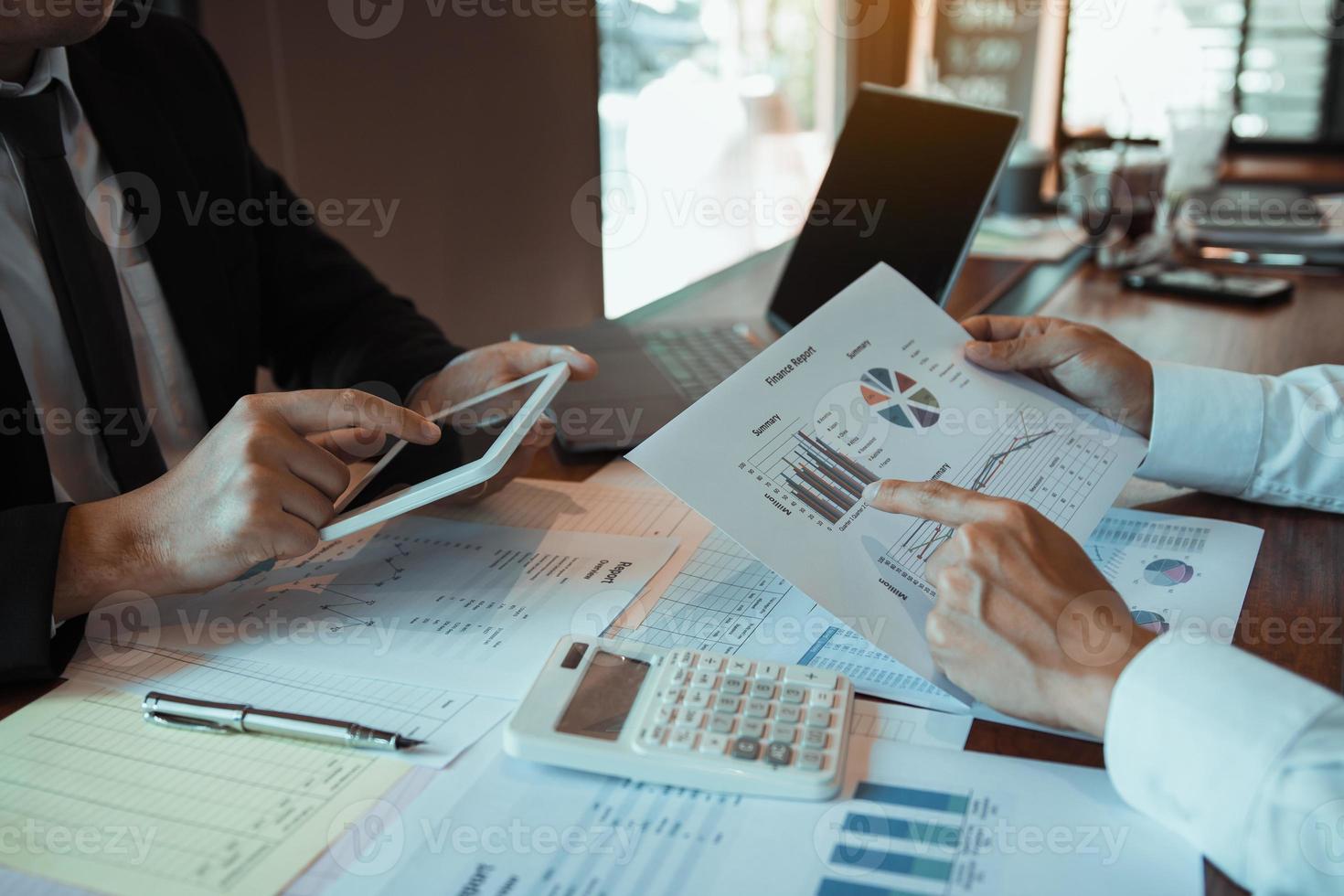 Business partnership coworkers using a tablet to analysis graph company financial budget report and cost work progress and planning for future in office room photo