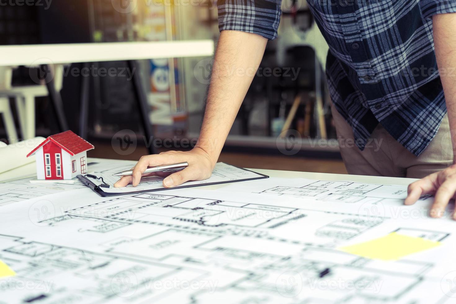 Engineers are designing working on blueprints and analyzing the structure of the project. photo