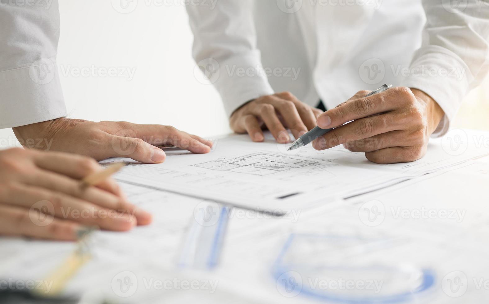 Team architect or engineering people discussion working on table together at a construction site. photo