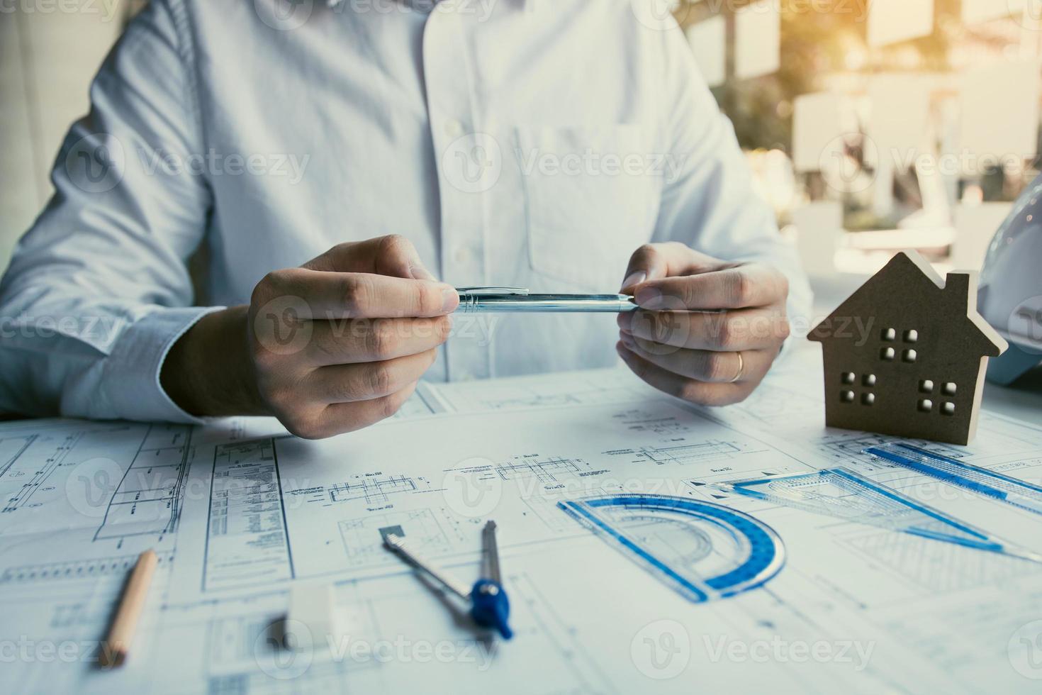 Engineers are designing working on blueprints and analyzing the structure of the project. photo