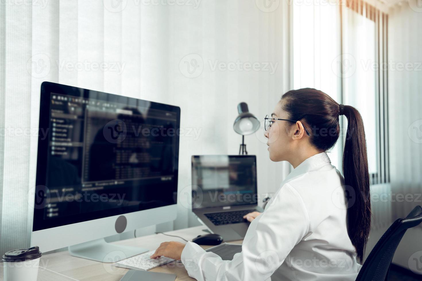 Developing programming and coding technology working in a software engineers developing applications in office. photo