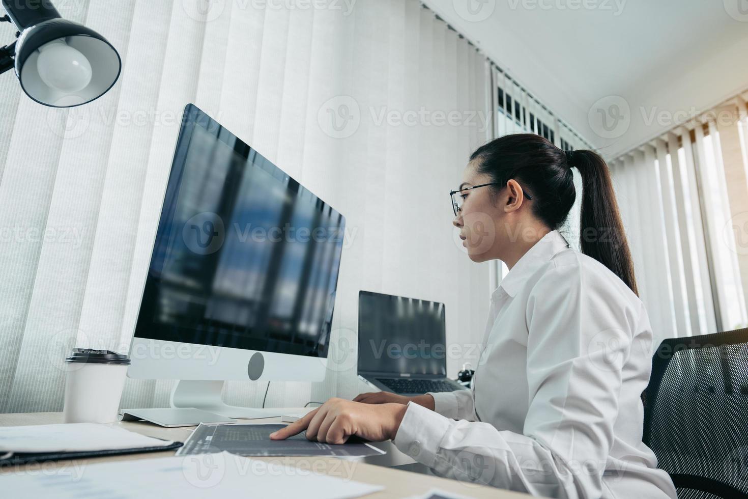 Woman asian software developers are analyzing together about the code written into the program on the computer in office room. photo