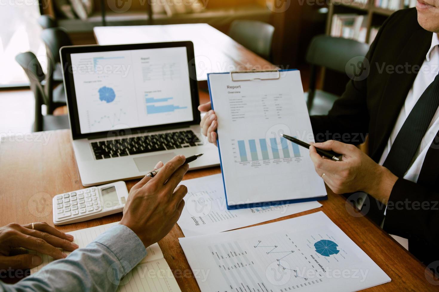 Two business partnership coworkers analysis strategy with discussing a financial planning graph and company budget during a budget meeting in office room. photo