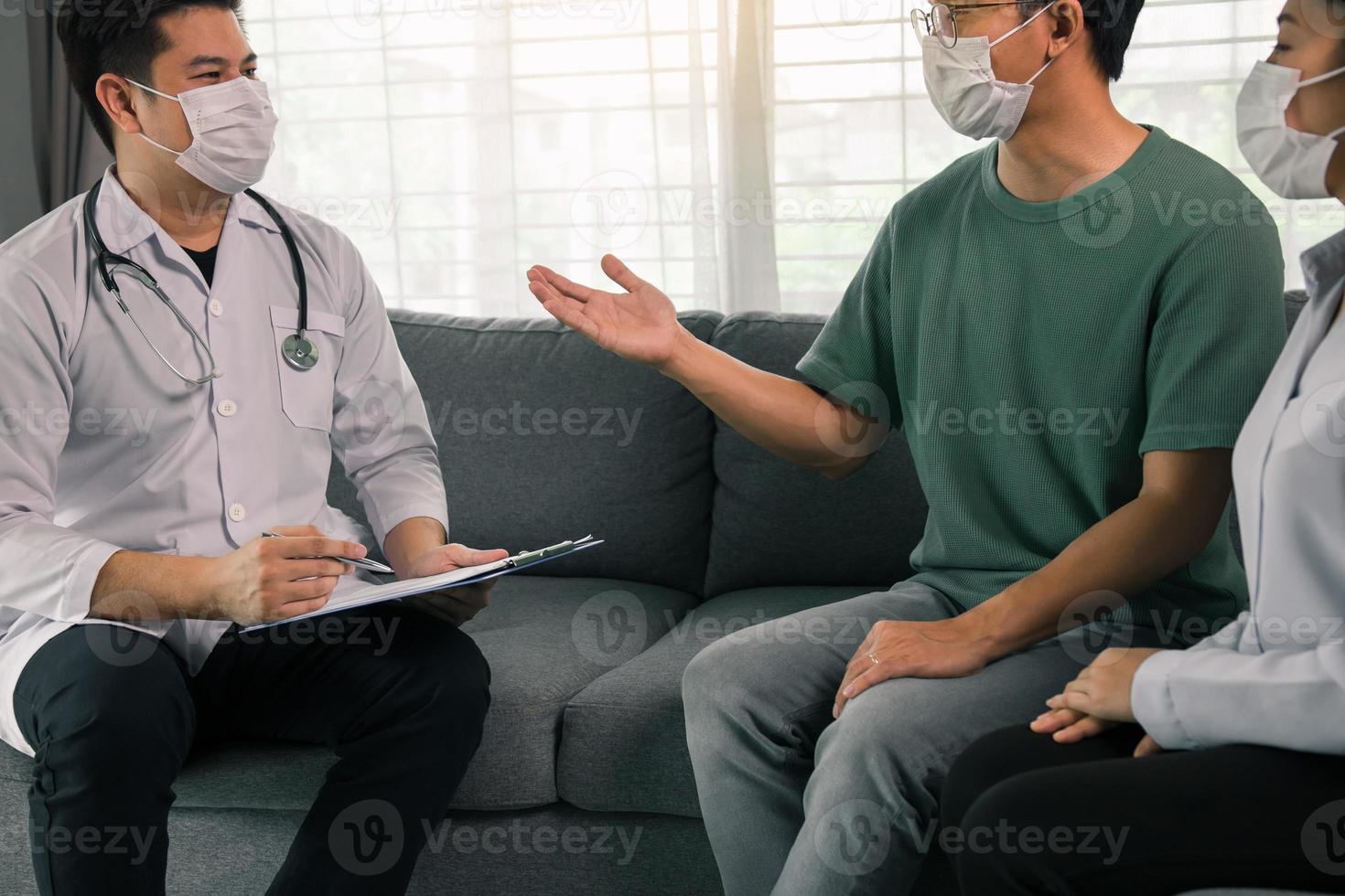 Asian couple is talking to a doctor about having a baby during an epidemic, as well as asking for advice on how to prevent the disease during the epidemic. photo