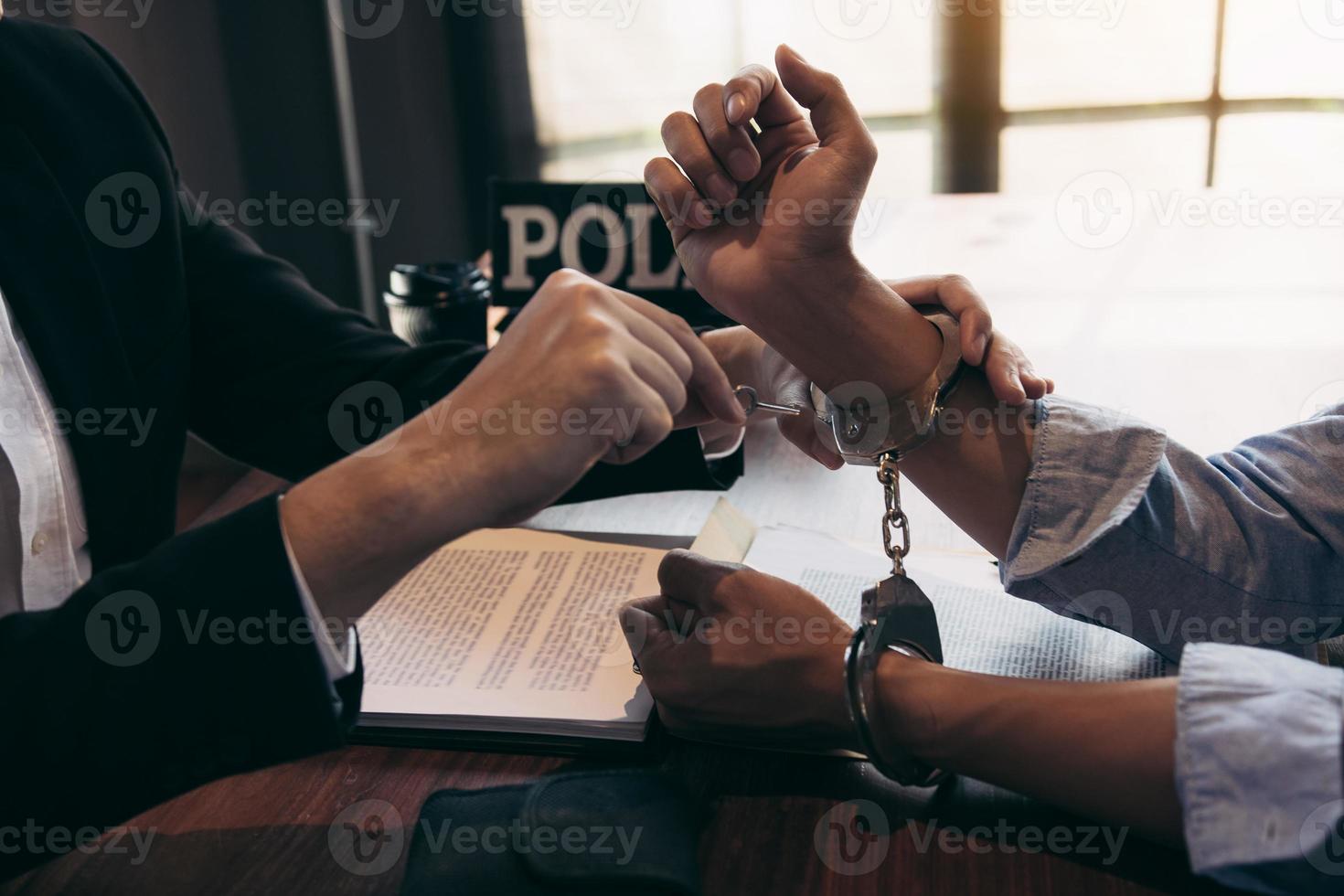 Police arrested the suspect and handcuffed him to acknowledge the allegation of the crime. photo