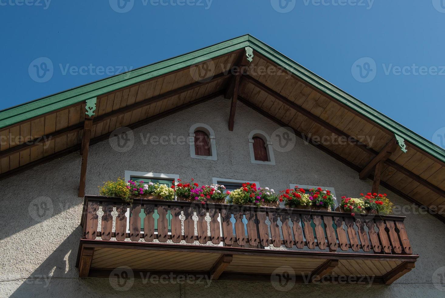 Flowers on wooden balcony photo