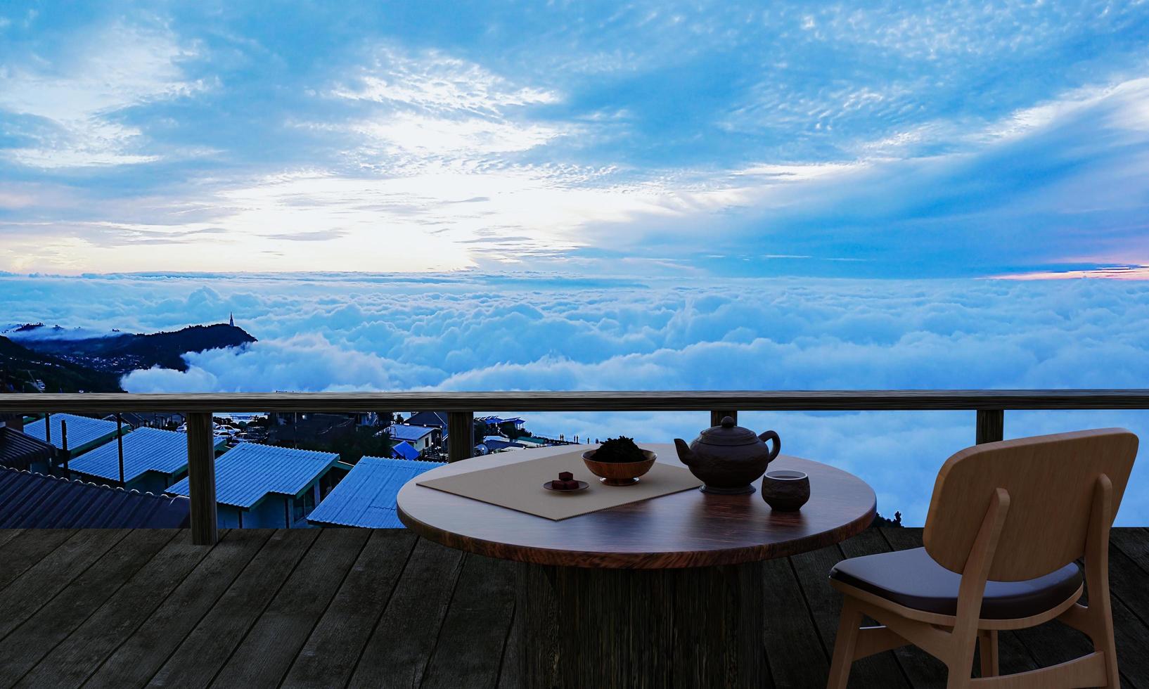 juego de té de cerámica y hojas de té secas sobre una mesa y silla de madera en el balcón o terraza de madera. montaña con mar matutino de niebla y sol. té caliente en el ambiente de montaña. representación 3d foto