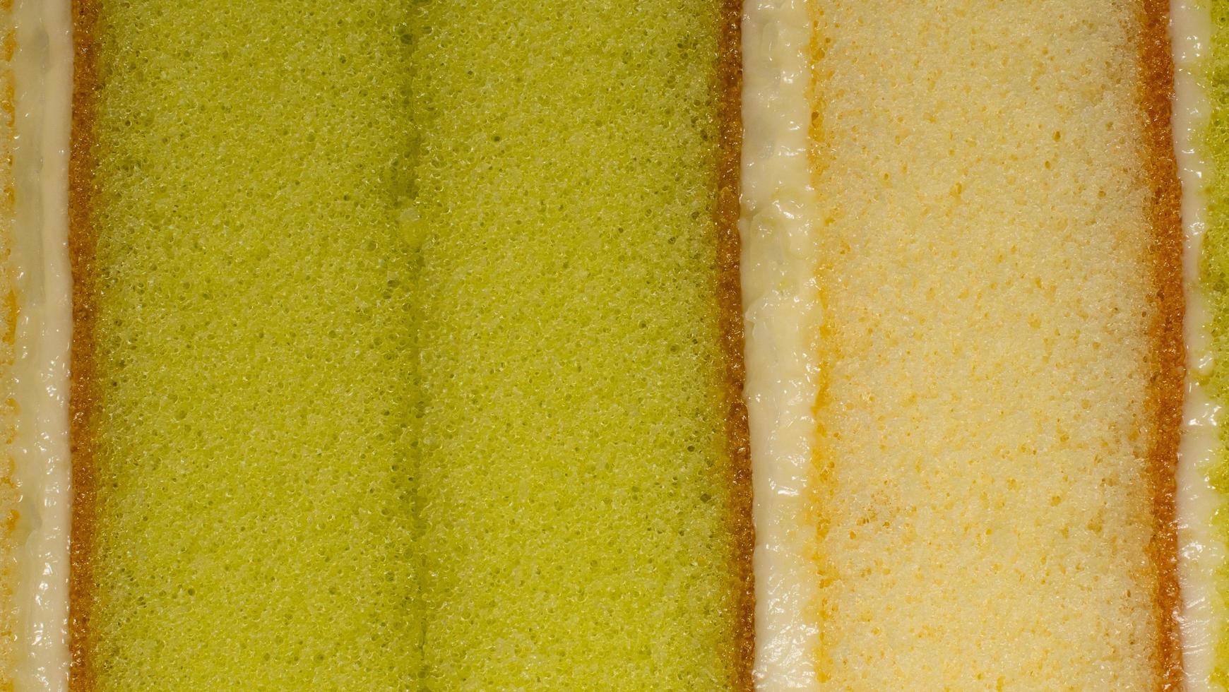 Sponge cake texture. Layer cake, center green pandan leaves and cream, topped with vanilla flavor. photo