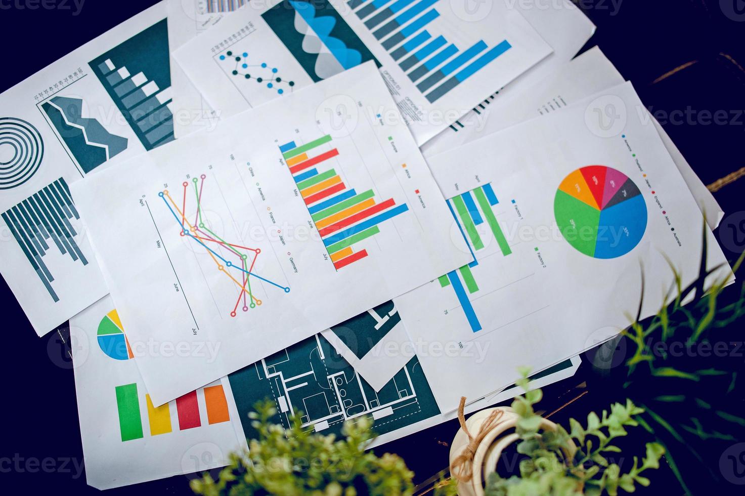 A desk with a business notebook, chart and table top. Top view with copy space photo